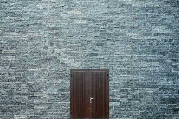 Restored stonework on a traditional terraced house in Cardiff, showcasing expert masonry craftsmanship and attention to detail.