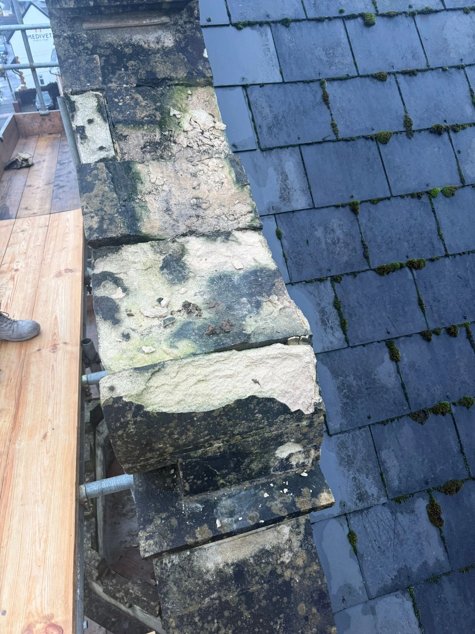 Before: Damaged roof stone requiring replacement
